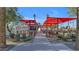Outdoor dining area with red canopies, picnic tables, and convenient access to a restaurant at 10650 E Palladium Dr, Mesa, AZ 85212