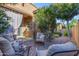 Covered patio offers a shaded retreat with comfortable seating and lush greenery, ideal for outdoor relaxation at 10650 E Palladium Dr, Mesa, AZ 85212