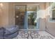Covered patio featuring tile flooring and a view through sliding glass doors, blending indoor-outdoor living at 10650 E Palladium Dr, Mesa, AZ 85212