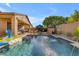 Gorgeous pool and patio area with outdoor seating, fountain features, and a built-in fireplace for outdoor relaxation and entertaining at 10650 E Palladium Dr, Mesa, AZ 85212