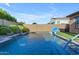 Backyard pool is the perfect spot for outdoor fun, featuring a basketball hoop, water features, and easy access to the house at 10650 E Palladium Dr, Mesa, AZ 85212