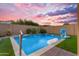 Stunning pool featuring fountain features, an artificial grass surround, and a patio area with space for seating and entertaining at 10650 E Palladium Dr, Mesa, AZ 85212