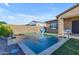 Beautiful pool with fountain features, a stone patio, and artificial grass offer a luxurious outdoor living experience at 10650 E Palladium Dr, Mesa, AZ 85212