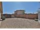 Backyard featuring gravel landscaping, block wall, and a view of the multi-story home at 12117 N 127Th Dr, El Mirage, AZ 85335