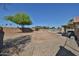 Spacious backyard with gravel landscaping, block wall, and a glimpse of the pool area at 12117 N 127Th Dr, El Mirage, AZ 85335