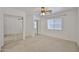 Bedroom with mirrored closet doors, ceiling fan, carpet and window at 12117 N 127Th Dr, El Mirage, AZ 85335