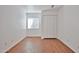 Bedroom with wood-look flooring, neutral paint, window, and closet at 12117 N 127Th Dr, El Mirage, AZ 85335