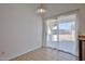 Bright dining area featuring tile floors, sliding glass door, and neutral paint tones at 12117 N 127Th Dr, El Mirage, AZ 85335