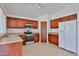 Well-lit kitchen featuring dark cabinetry, stainless steel appliances, and tile flooring at 12117 N 127Th Dr, El Mirage, AZ 85335