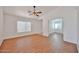 Bright living room featuring wood-look floors, white walls, and large windows for natural light at 12117 N 127Th Dr, El Mirage, AZ 85335