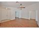 Spacious living room with wood-look flooring and neutral walls, with a ceiling fan at 12117 N 127Th Dr, El Mirage, AZ 85335