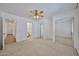 Spacious main bedroom with ceiling fan, mirrored closet doors, carpet and ensuite access at 12117 N 127Th Dr, El Mirage, AZ 85335