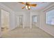 Spacious main bedroom with ceiling fan, mirrored closet doors, and ensuite access at 12117 N 127Th Dr, El Mirage, AZ 85335