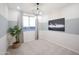 A staged bedroom features neutral tones, modern light fixture, and a hockey-themed art piece at 13244 N 146Th Ln, Surprise, AZ 85379