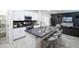 A stylish kitchen featuring a center island with bar stools, modern appliances, and sleek design at 13244 N 146Th Ln, Surprise, AZ 85379