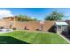 Backyard featuring artificial turf, a playhouse, a basketball hoop, and outdoor seating at 14338 W Bronco Trl, Surprise, AZ 85387