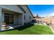 A charming backyard with a patio set, artificial turf, and a hammock for relaxed outdoor living at 14338 W Bronco Trl, Surprise, AZ 85387