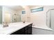 Bathroom features double sinks, a soaking tub, and a separate glass enclosed shower at 14338 W Bronco Trl, Surprise, AZ 85387