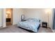 Cozy bedroom with carpet, decorative bedding, and ensuite bathroom at 14338 W Bronco Trl, Surprise, AZ 85387