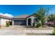 Charming single-story home featuring a well-manicured lawn, neutral paint, and a two-car garage at 14338 W Bronco Trl, Surprise, AZ 85387