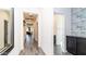 Bright hallway features tile floors, fresh white walls, and decorative accents at 14338 W Bronco Trl, Surprise, AZ 85387