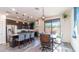 Bright kitchen with stainless steel appliances, dark cabinets, granite counters, and a large center island at 14338 W Bronco Trl, Surprise, AZ 85387