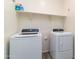 Convenient laundry room equipped with modern washer and dryer units at 14338 W Bronco Trl, Surprise, AZ 85387