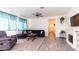 Spacious living room with tile floors, natural light, ceiling fan, and comfortable seating at 14338 W Bronco Trl, Surprise, AZ 85387