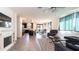 Open-concept living area with tile floors and fireplace flows into a kitchen with stainless steel appliances and dark cabinetry at 14338 W Bronco Trl, Surprise, AZ 85387