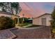 Backyard of home featuring a stone patio, gazebo, and stepping stones in the grass at 1522 W Willetta St, Phoenix, AZ 85007