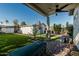 Backyard with artificial turf and a covered patio area, offering an ideal outdoor living space at 1522 W Willetta St, Phoenix, AZ 85007