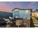 Outdoor patio space features six modern chairs around a brick area and a detached garage at 1522 W Willetta St, Phoenix, AZ 85007