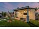 Charming covered patio with outdoor seating area, ceiling fans, and a television at 1522 W Willetta St, Phoenix, AZ 85007