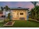 Backyard patio with covered seating area, a ceiling fan, and an outdoor television at 1522 W Willetta St, Phoenix, AZ 85007