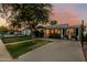 Inviting single-story home boasting a cozy front porch, manicured lawn, and brick paved driveway at 1522 W Willetta St, Phoenix, AZ 85007