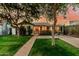 Charming single-story home with lush green lawn, mature trees, and welcoming front entrance at 1522 W Willetta St, Phoenix, AZ 85007