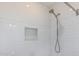 Modern shower with white subway tiles, a niche for storage, and a handheld showerhead at 1522 W Willetta St, Phoenix, AZ 85007