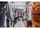 Spacious walk-in closet featuring custom wood drawers, shelving and hanging storage for organization at 1522 W Willetta St, Phoenix, AZ 85007