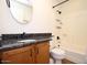Bathroom features wood cabinets, black hardware, shower, and toilet at 16644 N 33Rd St # 101, Phoenix, AZ 85032