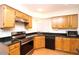 Bright kitchen featuring wood cabinets and modern appliances at 16644 N 33Rd St # 101, Phoenix, AZ 85032