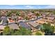 Overview of houses with solar panels from above, situated in a well-kept, green neighborhood at 17115 N Larkspur Ln, Surprise, AZ 85374