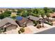 Aerial view of home showcasing solar panels and proximity to community lake at 17115 N Larkspur Ln, Surprise, AZ 85374
