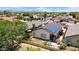 An aerial view of a home's backyard featuring a patio area and solar panels on the roof at 17115 N Larkspur Ln, Surprise, AZ 85374