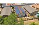 A home features solar panels on the roof and a patio area in the backyard, captured in this aerial shot at 17115 N Larkspur Ln, Surprise, AZ 85374