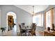 Dining room with neutral colors, tile flooring, and archway to kitchen at 17115 N Larkspur Ln, Surprise, AZ 85374
