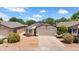 Charming single-story home with low maintenance desert landscaping and a two-car garage at 17115 N Larkspur Ln, Surprise, AZ 85374