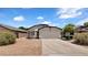 Charming single-story home with a two-car garage and low maintenance desert landscaping at 17115 N Larkspur Ln, Surprise, AZ 85374