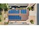 Aerial view displays home's roof adorned with solar panels, with a charming backyard at 17115 N Larkspur Ln, Surprise, AZ 85374