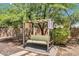 Relaxing backyard featuring a covered swing set under a lush, leafy tree for leisure and tranquility at 1755 E Tonto Dr, Chandler, AZ 85249