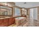 Bathroom features a large soaking tub, dual sinks, and a glass block window at 1755 E Tonto Dr, Chandler, AZ 85249